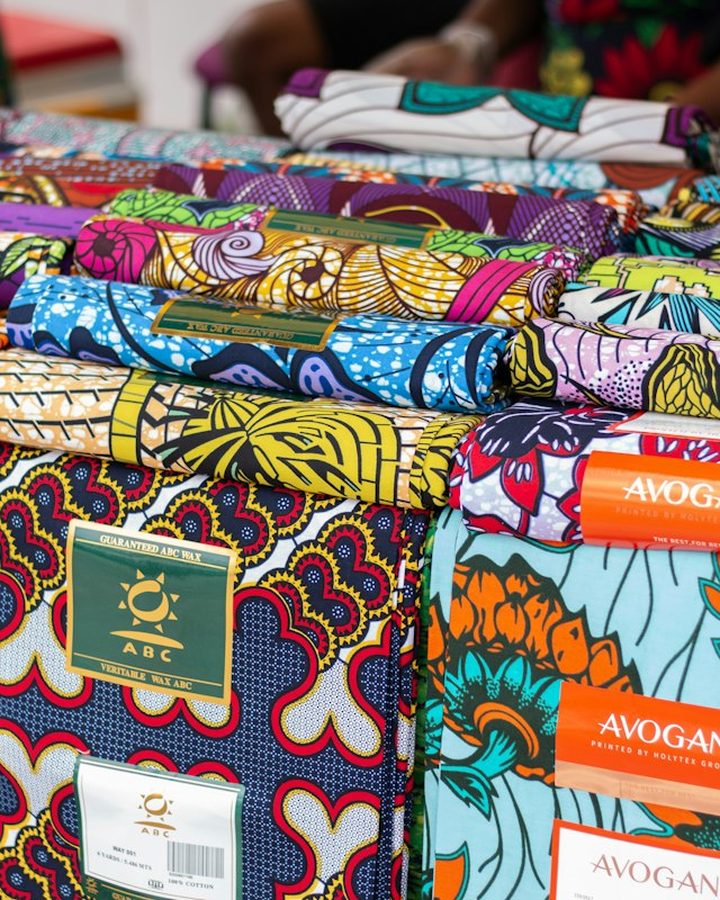 Stacks of colourful African print fabric for sale